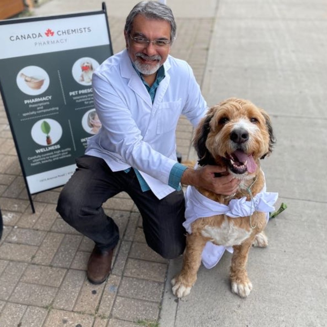 Our Pharmacist Amin with one of our patients & friends, Milo.